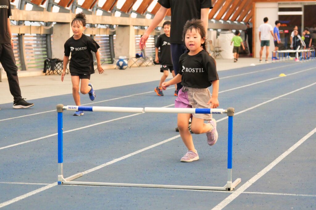 ミニハードル練習で走り方を整える小学生